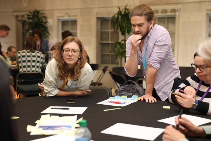 People around a table for a Future Fridays workshop. On the right is luminary Eli Holder.