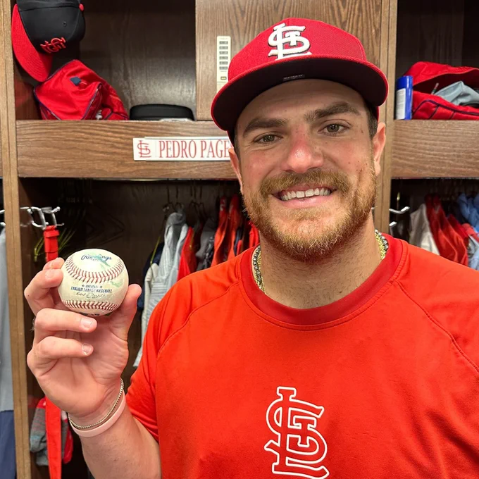 Cardinals catcher Pedro Pages holds the baseball he hit for his first Major League home run
