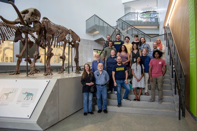 Photo of paleontologists with mastodon skeleton.