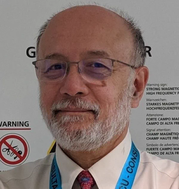 A man in glasses smiling 