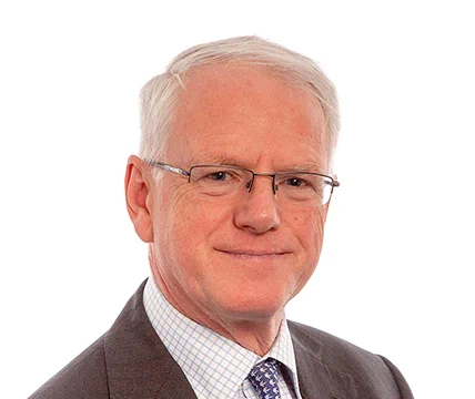 A man in glasses, smiling 