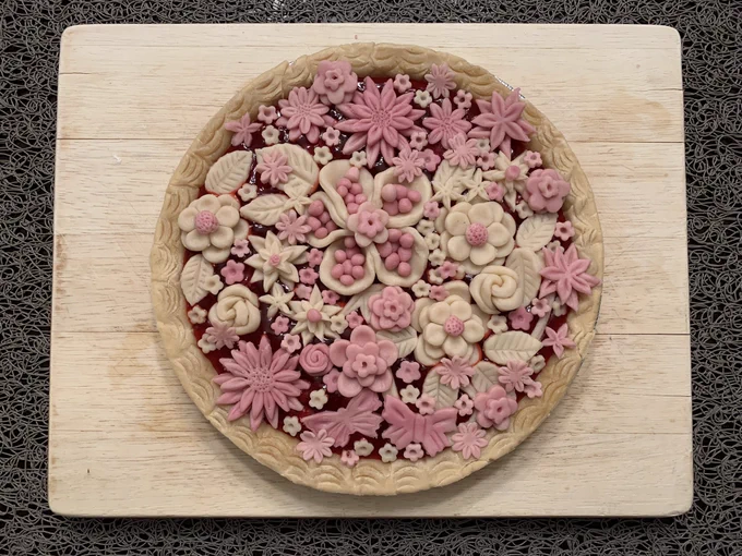 Homemade pie with sculpted pink flowers.