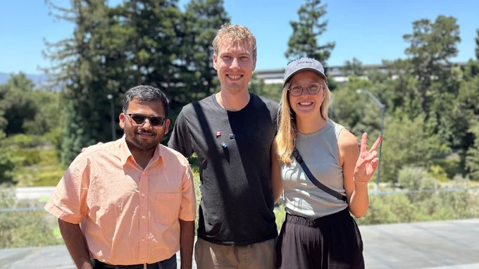 From left to right, Vidit (Me), Kai, and Malin smiling at the camera with Apple Park in the backdrop.