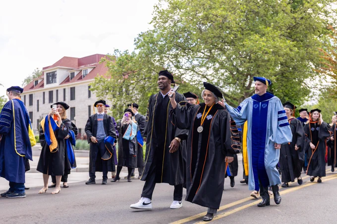  OSU commencement speaker Steven Jackson, President Jayathi Murthy and Provost Ed Feser in processional on campus. 
