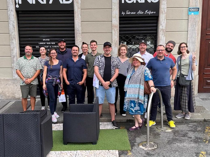 GoDaddy team photo on the sidewalk in Torino.