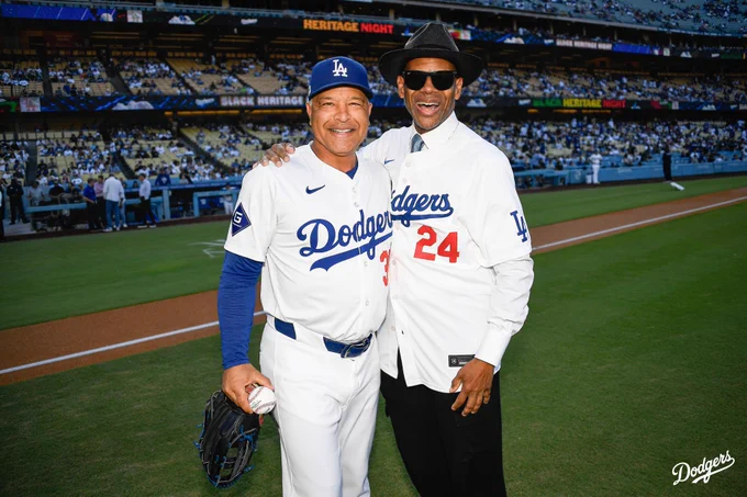 A photo of Dave Roberts and Jimmy Jam on the field after the first pitch.