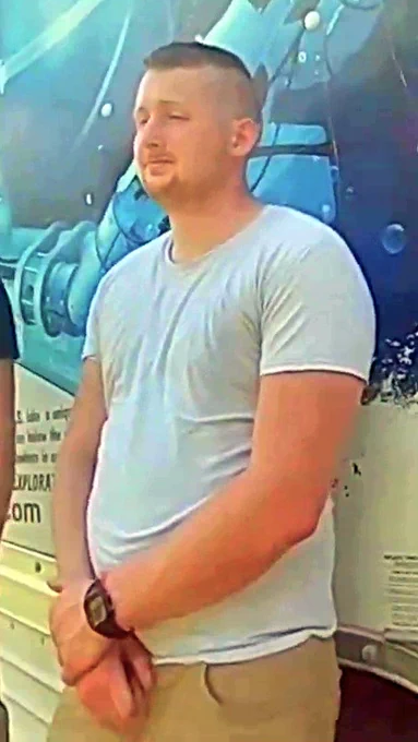 A video still of bodycam footage, edited by the Boston Globe, depicting Keith Mathew Ray of Williamsport PA. He is standing in parade rest in front of a UHaul truck, after the driver was pulled over.