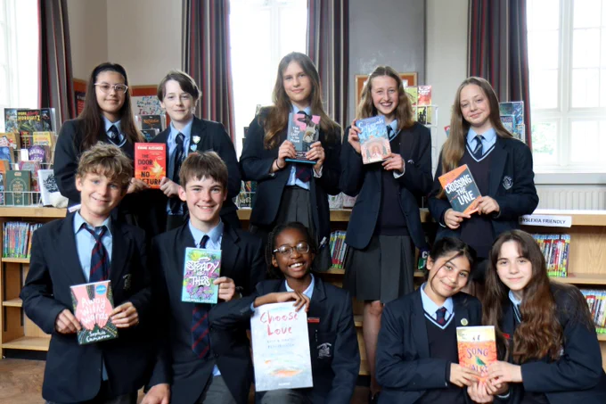 Image of a shadowing group holding the Yoto Carnegies 2024 Writing shortlist