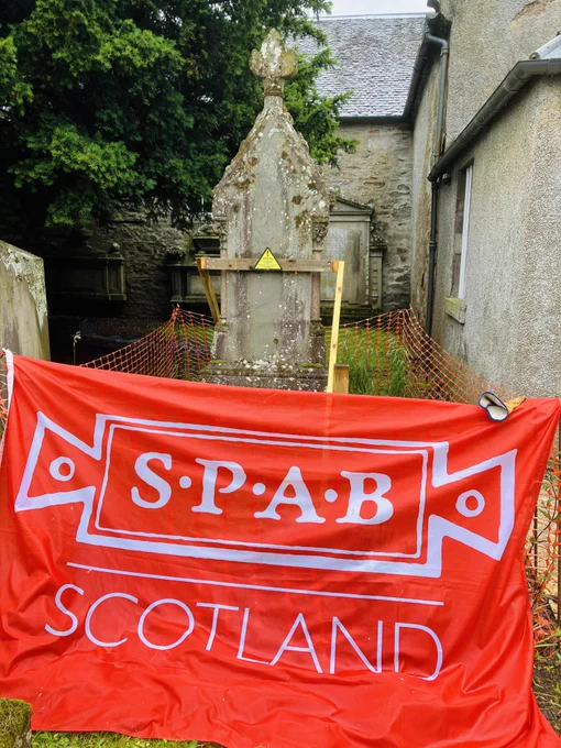 A bright red banner with the words 'SPAB Scotland', a church building in the background