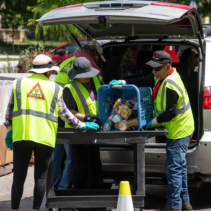 Staff emptying HHW from a tote at an event