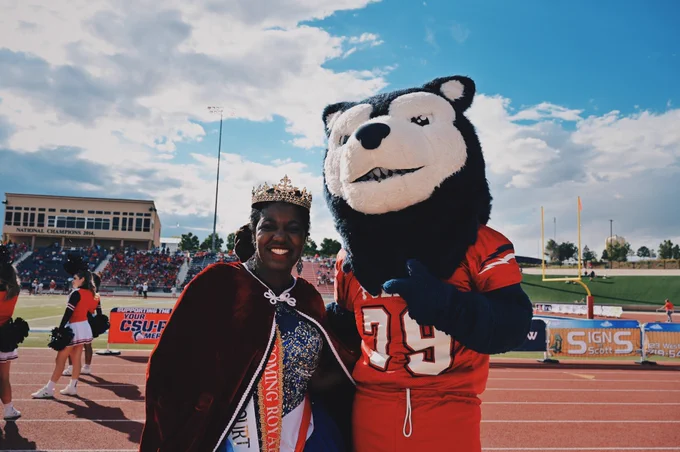 Wolfie taking a photo with a homecoming queen