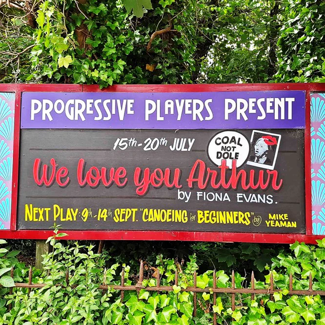 Hoarding painted with a poster promoting We Love You Arthur, by Fiona Evans, 15 to 20 July.