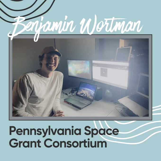 Image Description: Ben W. smiling, sitting at a computer station, completing research project.