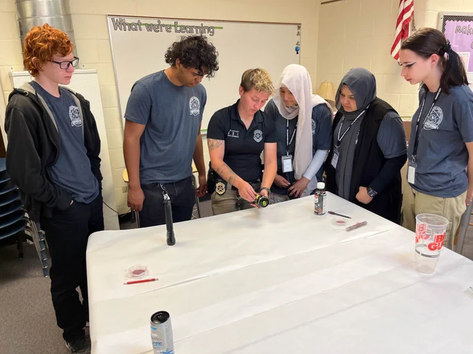A group of students learn about first responders and law enforcement at the Youth Police Academy.