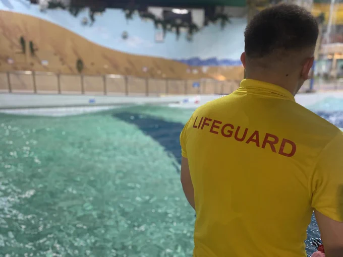 At Waterworld, with a young man wearing a yellow t-shirt with 'Lifeguard' on the back