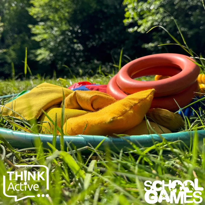 [Image shows some bean bags and rings inside of a hoop on the ground above the School Games and Think Active logos]
