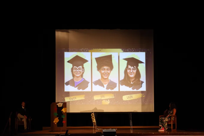 A slide show has caricatures of the graduates.