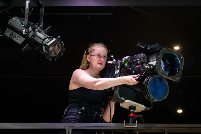 A student controls the direction of stage lights. Photo credit: Steve Gregson
