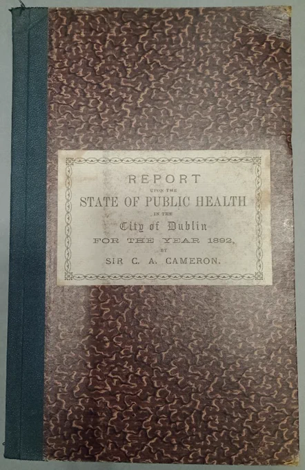 A book with a brown patterned cover and title "Report upon the state of public health in the city of Dublin for the year 1892".