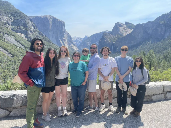 A group of people in front of half dome at Yosemite