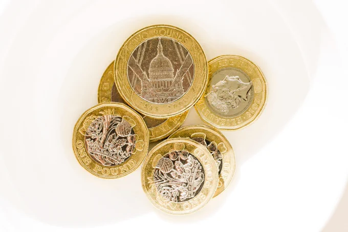 a photograph of a small pile of one and two pound coins