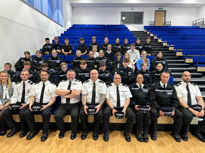 A photo of officers and staff sat with Chief Constable Tim Smith 