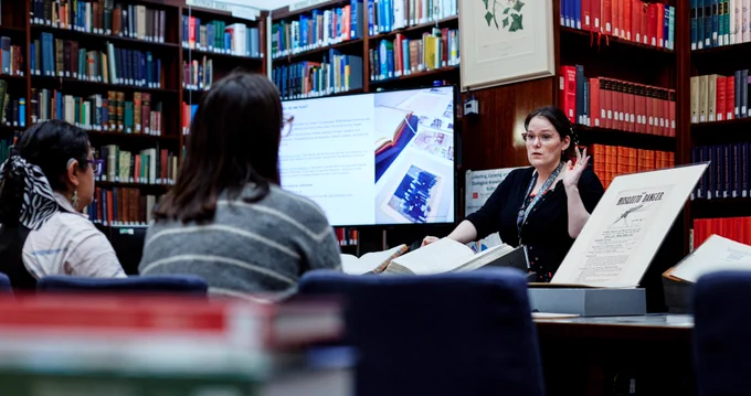 Member of staff giving a presentation in the library.