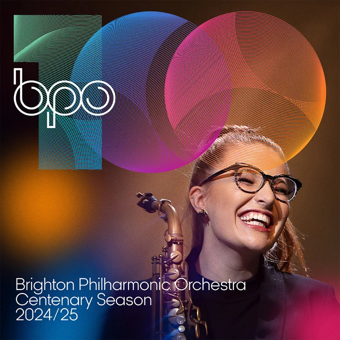 The text reads 'BPO 100. Brighton Philharmonic Orchestra. Centenary Season. 2024/25.

Saxophonist Jess Gillam smiles. 