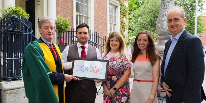 Pat Guiry, Billy McCarthy, Christine O'Connor, Niamh O'Boyle and Hugh Fay stand outside the Royal Irish Academy, 19 Dawson Street, Dublin 2. Billy McCarthy is holding a framed certificate.