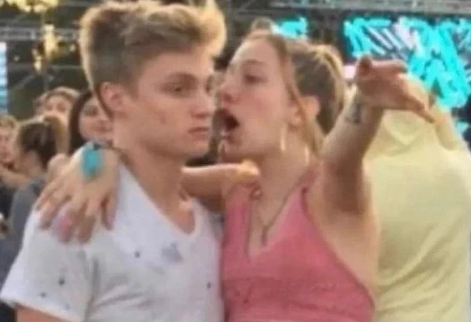 Meme image of a young woman yelling into the ear of a young man while gesturing emphatically 