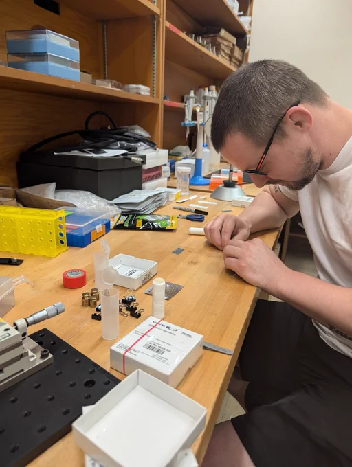 Sean Currier working at a lab bench to prepare samples.