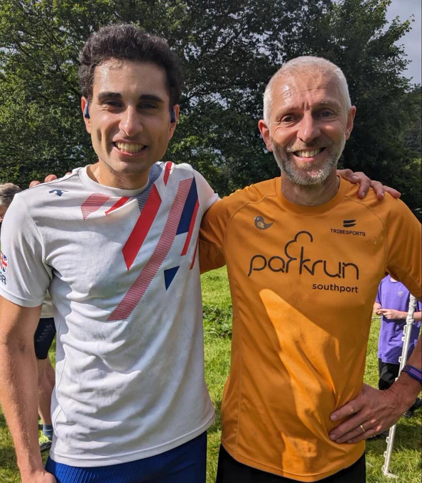 Simon in parkrun apricot T shirt with Hussain in GB triathlon top at Rothay Park parkrun