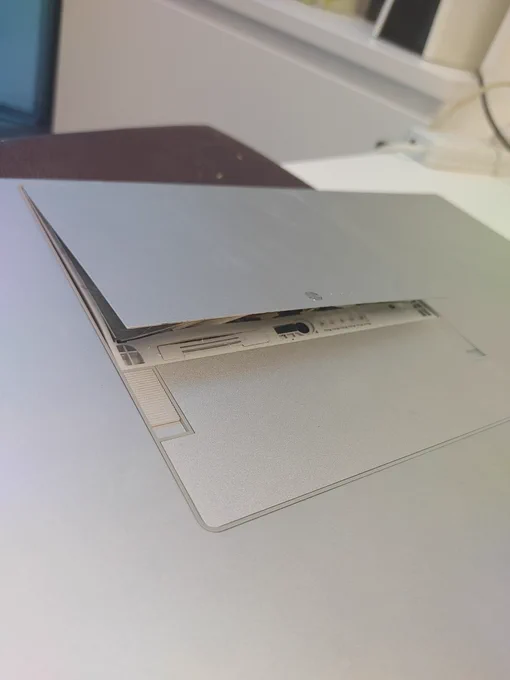 Battery protruding from back of a laptop, has expanded case.