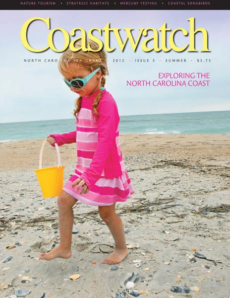 Cover of the 2012 summer issue of Coastwatch magazine.  Little girl in pink swimsuit at the beach