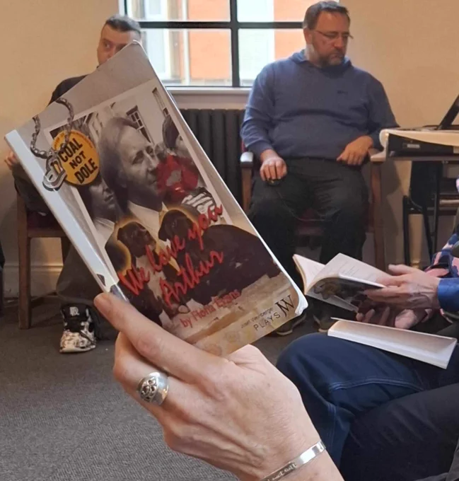A script for We Love You Arthur being held up and read.