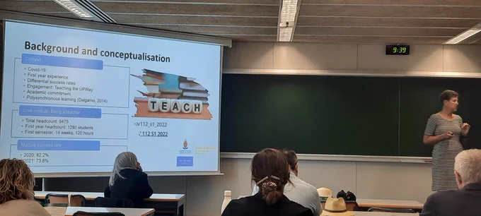 PowerPoint slide providing overview of presentation.  On the right is Salome, the presenter. The photo was taken from the back if the room so the back of some people's heads appear to the forefront of the photo