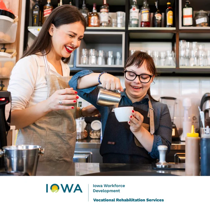 A photograph of a worker and a manager at a coffee shop. The manager is showing the worker job duties as she is pouring coffee as a barista. The image also features the Iowa Vocational Rehablitation Services logo. 