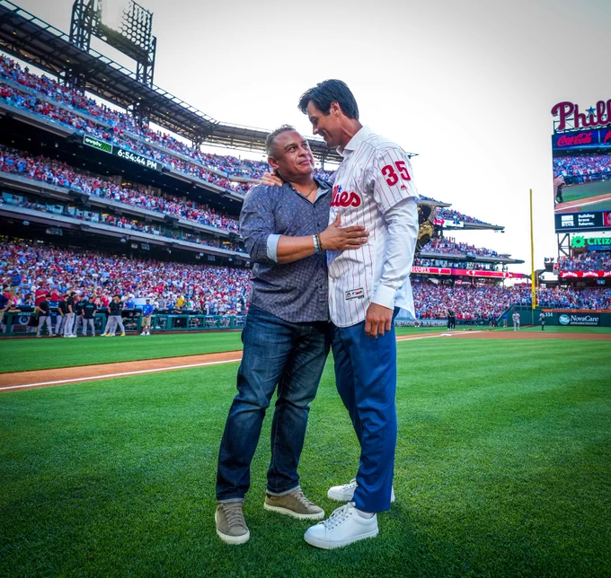 Cole Hamels and Carlos Ruiz hug following Cole's first pitch