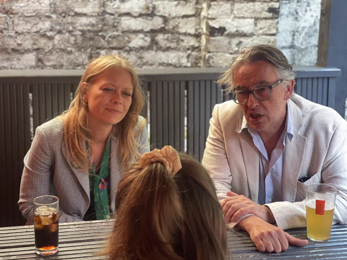 Sian Berry and Steve Coogan at a pub table talking to a journalist in Brighton.