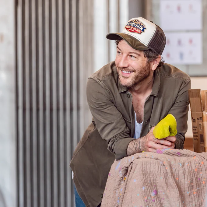 Matt Cardle in rehearsals for & Juliet - smiling and leaning, watching on.