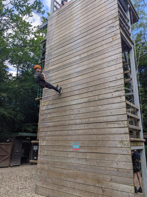 A Scout abseiling down a wall