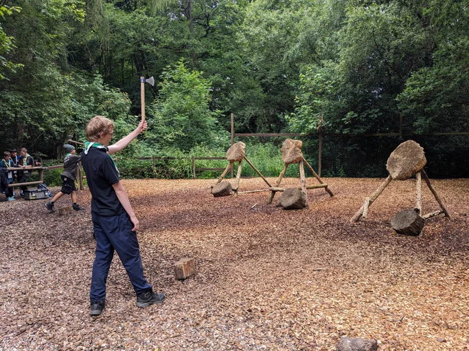 A Scout about to throw a tomahawk at a target