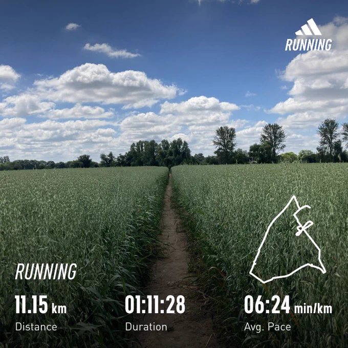 Path running directly through the middle of a field with trees on the horizon; running stats overlayed (distance=11.15km, time=1:12:28)