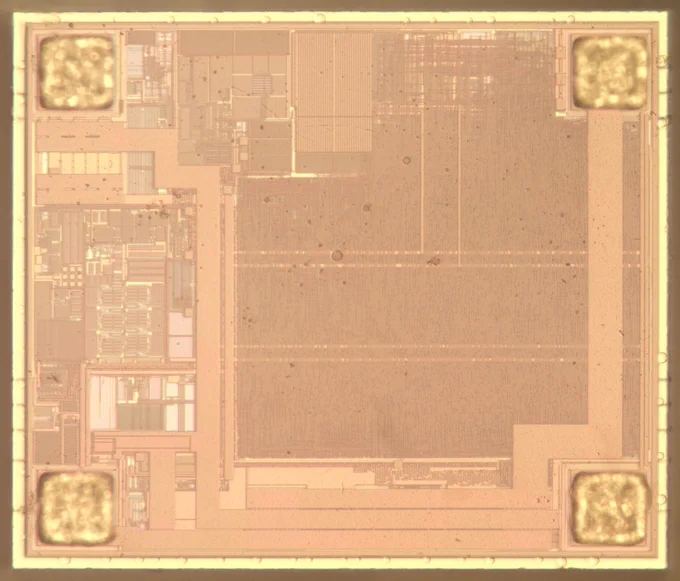 Die photo of a chip, showing various patterns on the chip's surface. This photo shows the top metal layer, consisting of thick and very thin wiring.