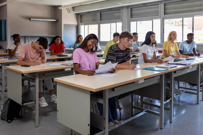 Young group of high school students studying in classroom 