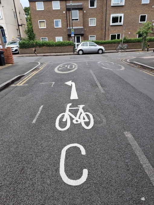Cycle symbol, direction arrow and large letter C painted on Cavendish Road, SW19
