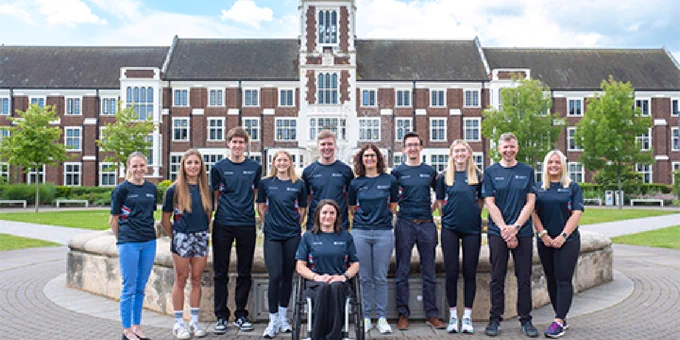 image displaying Paralympic members lined up infant of hazel rig building .