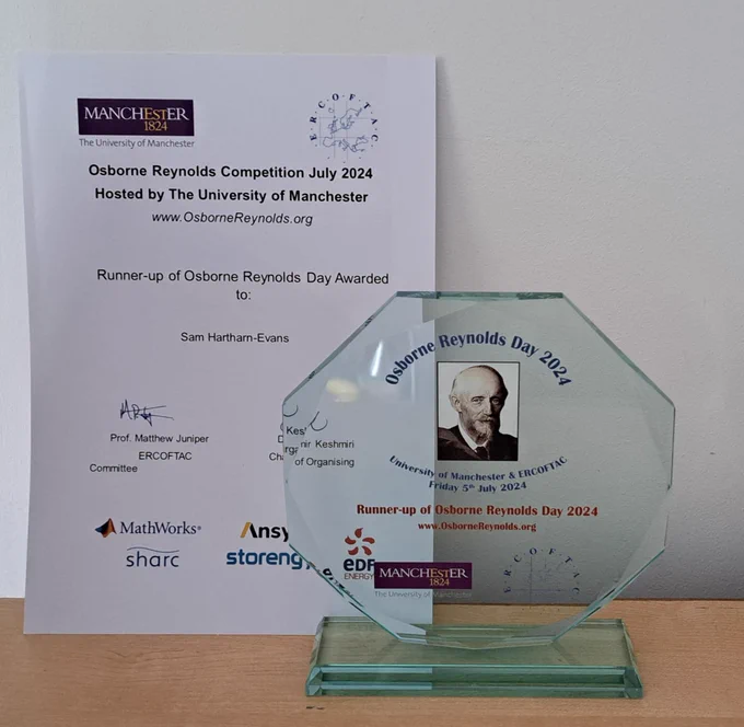 Photo of a certificate for the Osborne Reynolds Competition, and the glass trophy  