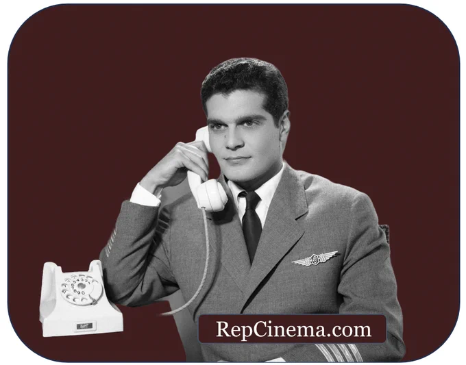 A cut-out black and white photo of Omar Sharif wearing a pilot's uniform and holding a telephone against a burgundy backdrop with " RepCinema.com " overlaid. Image courtesy of Akkasah.org