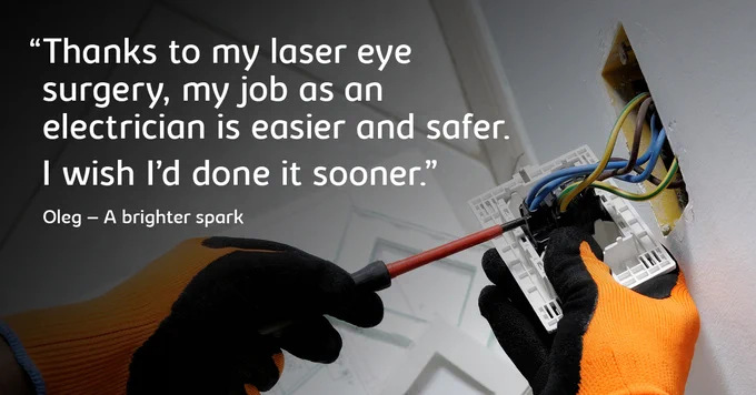 Hands wearing protective gloves, holding a screwdriver fixing a plug socket.